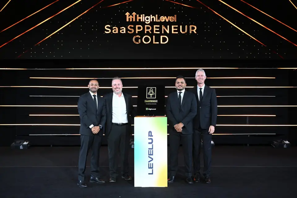 Jonathan Ferrell on stage with the HighLevel team at LevelUp, with the SaaSpreneur Gold award